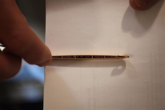 A Cartier amethyst and 18ct gold bar brooch, channel-set with 29 square-cut rubies, signed Cartier, Paris numbered 3056?,